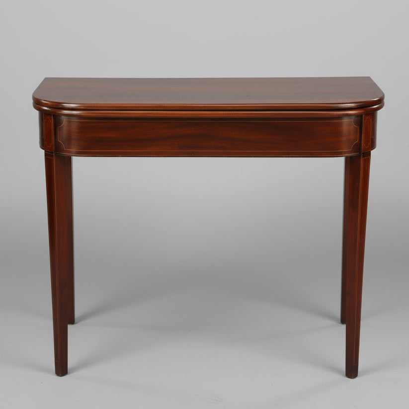 Wooden table on a stone patio with decorative elements in the background