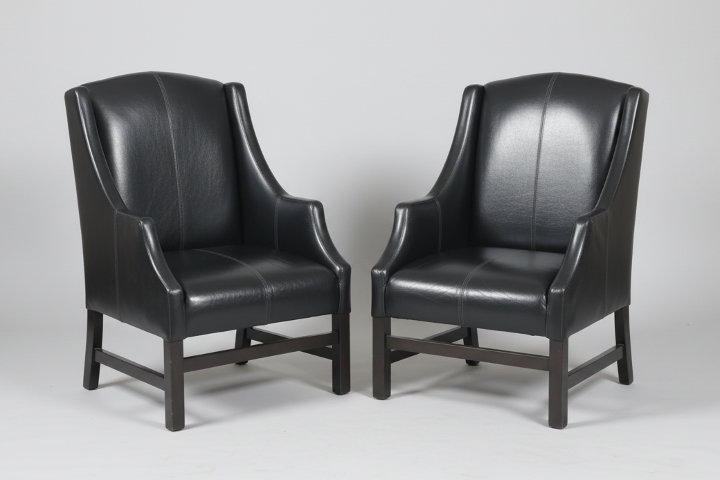 Pair of black leather Armchairs, the back upholstered in Nguni hide.