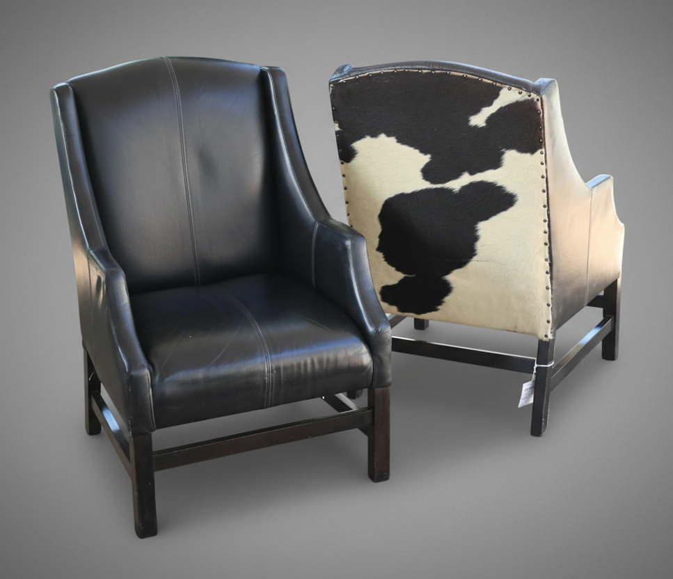 Pair of black leather Armchairs, the back upholstered in Nguni hide.