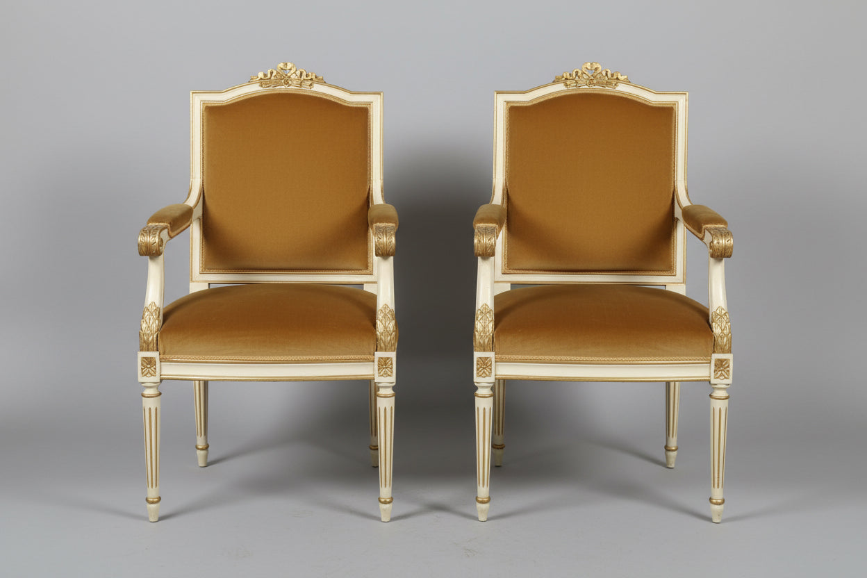 Two Pairs of Neoclassical or Louis XVI style painted and parcel-gilt Open Armchairs