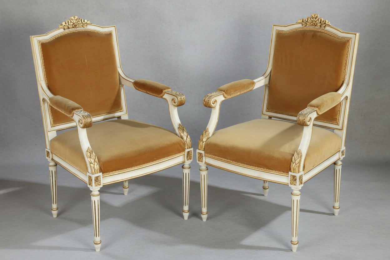 Two Pairs of Neoclassical or Louis XVI style painted and parcel-gilt Open Armchairs